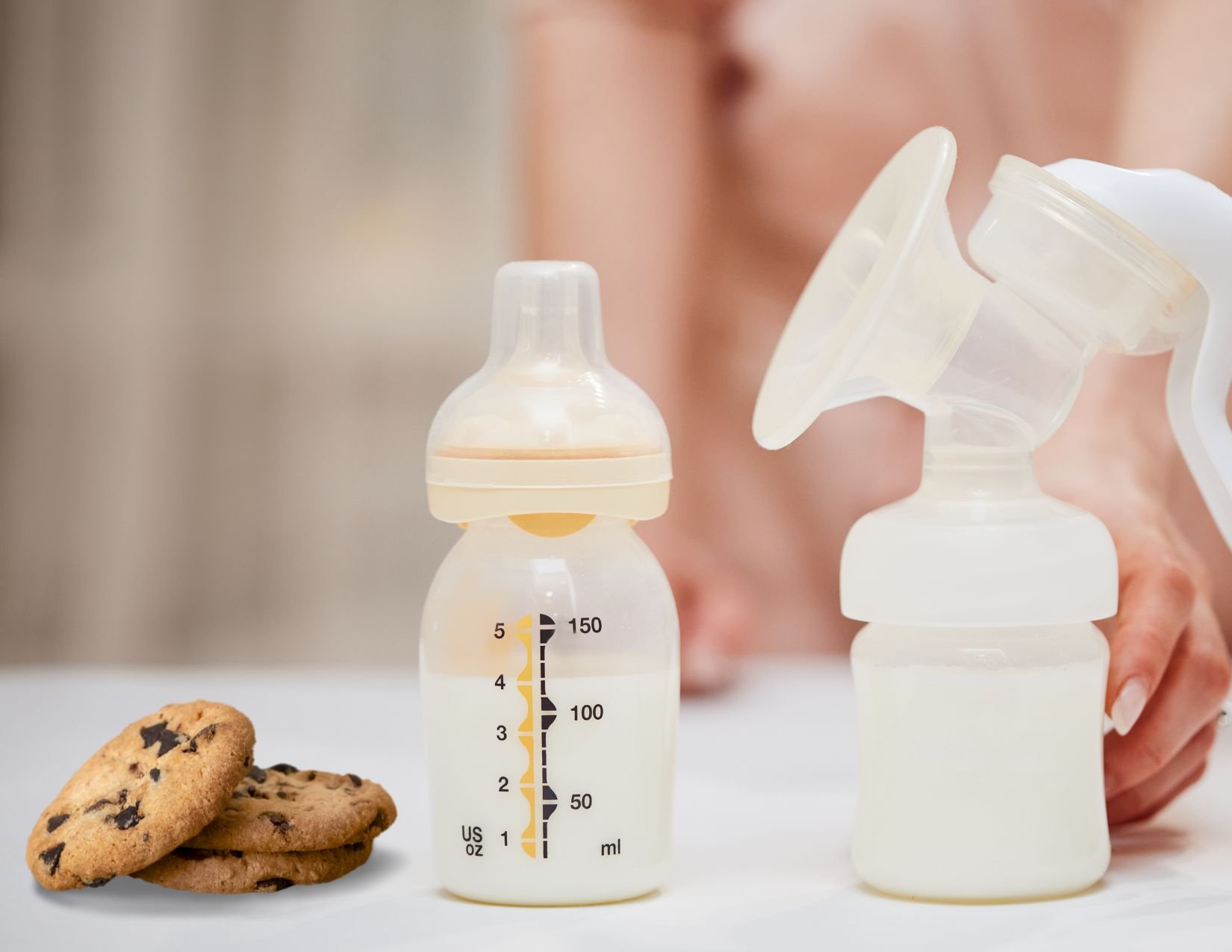 cookies sitting on table next to pumped breast milk suggesting relationship between these two things